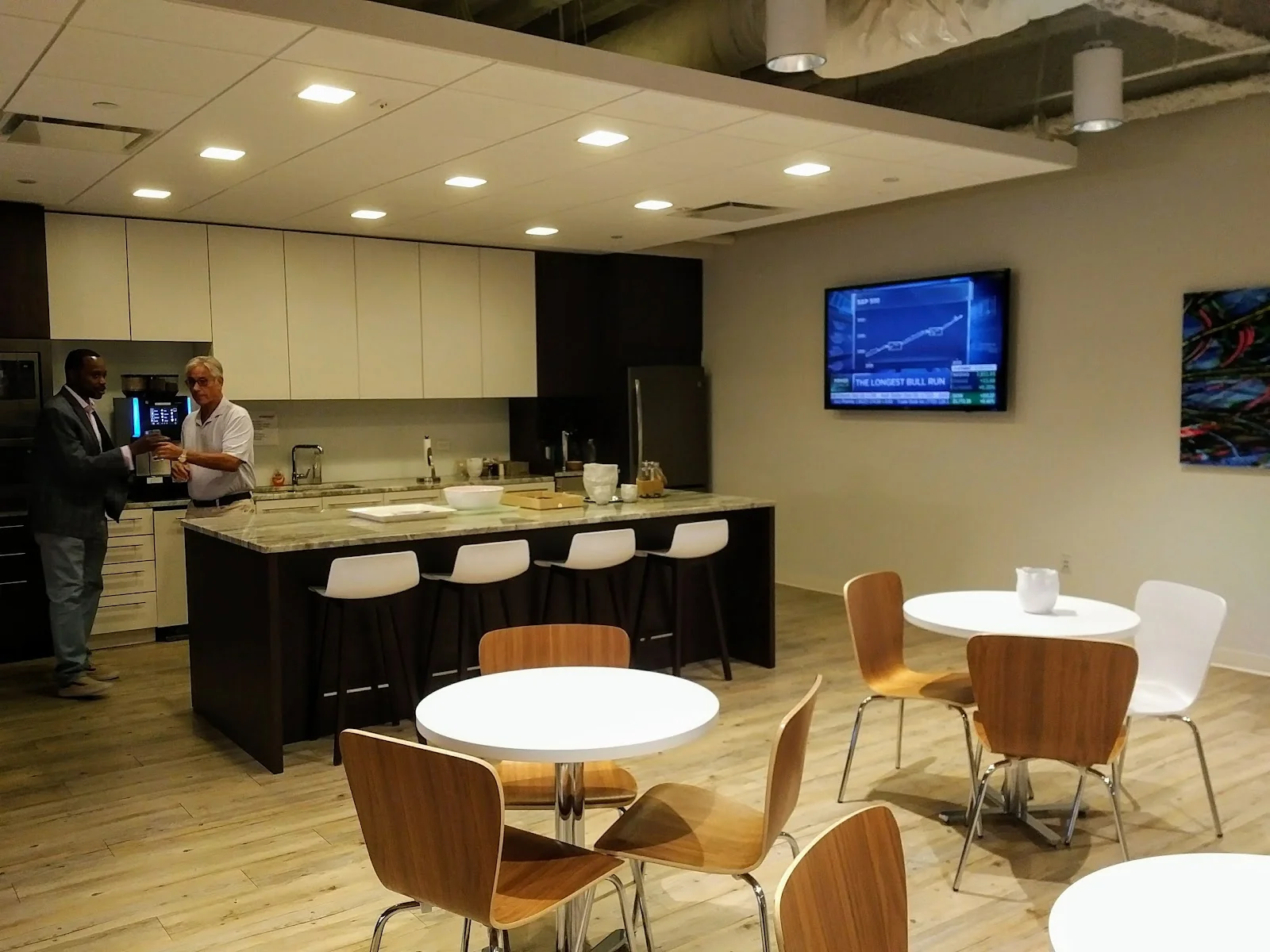 Workpoint Stamford - modern break room with kitchen island and business TV